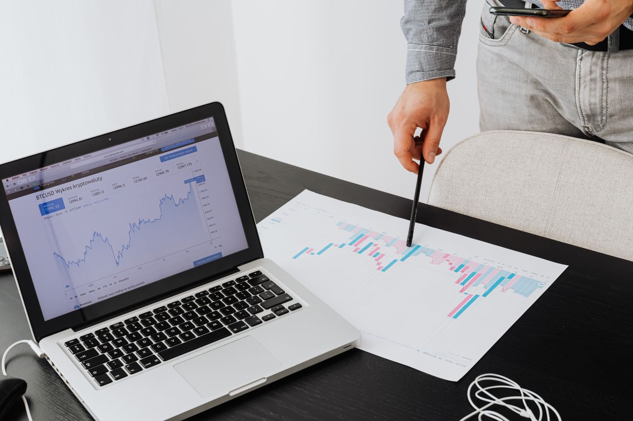 about-02 Person analyzing cryptocurrency data using a laptop, highlighting financial insights.